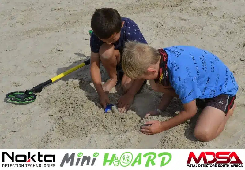 Kids digging for treasure while metal detecting